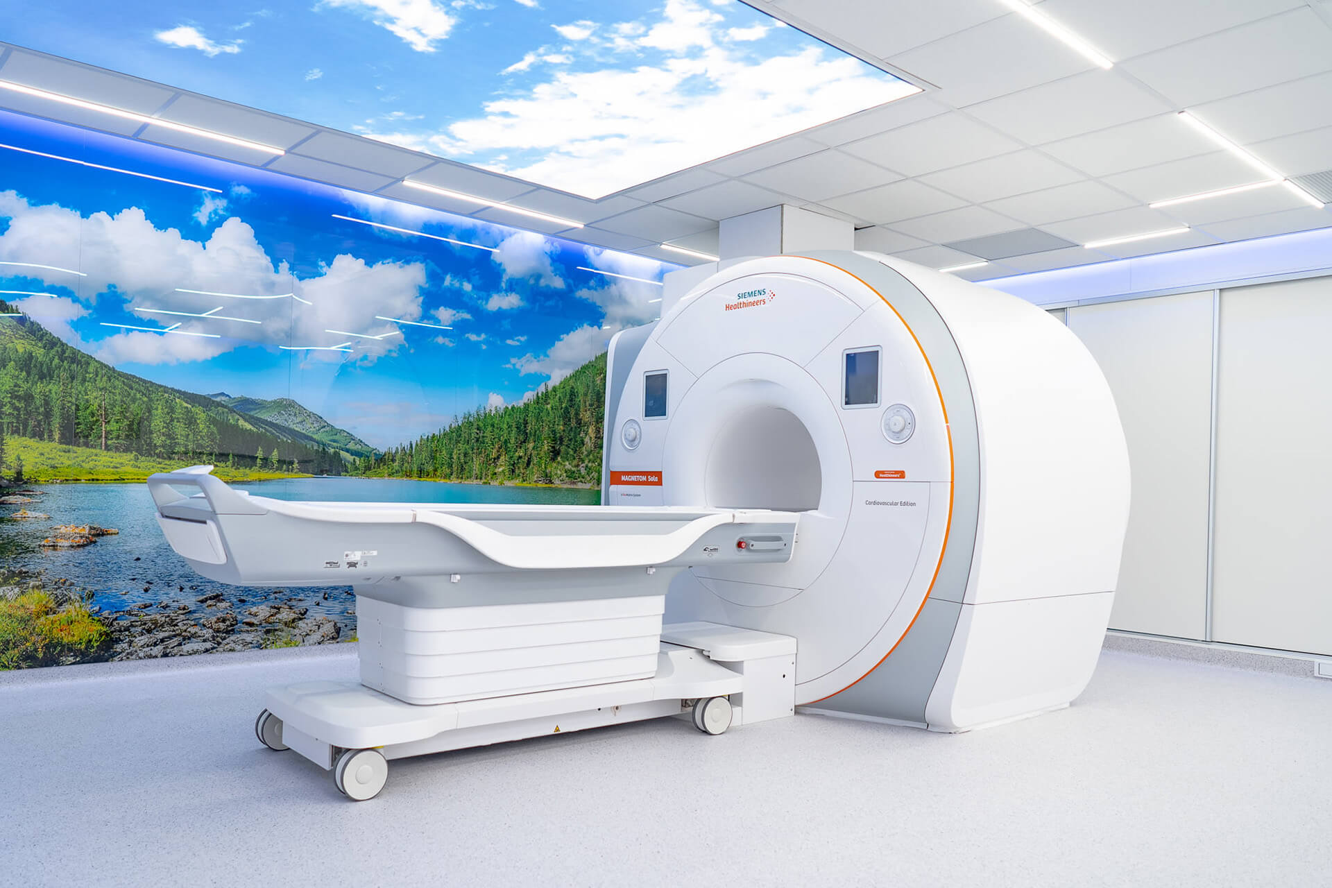 Humanized MRI room with mood lighting and landscape wall decal