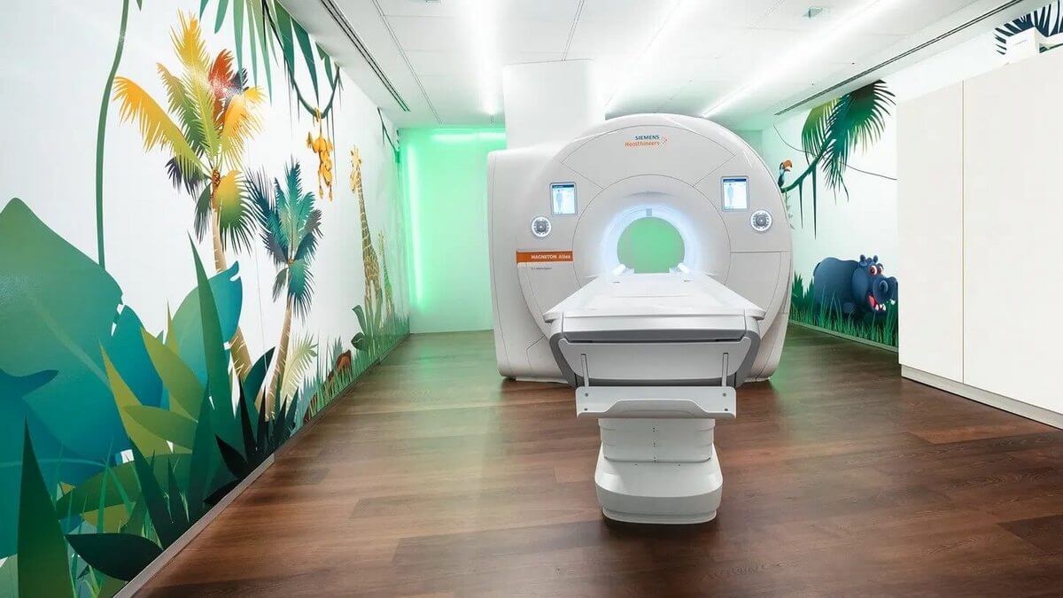 Patient entering an MRI scanner bore with surrounding shielded room infrastructure